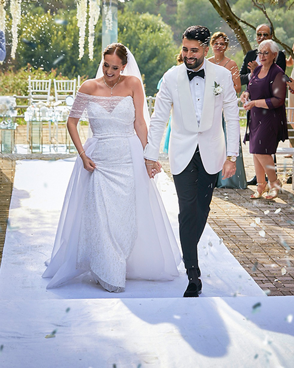 Wedding couple walking on white carpet
