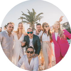 Photo of a large and cheerful group of people at a wedding in Mykonos