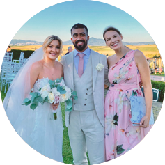 Bride, groom and event host standing on green mountain in Skiathos